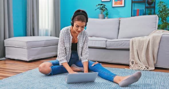 A Teenager Writes a Paper a Test Sitting on the Floor in the Living Room