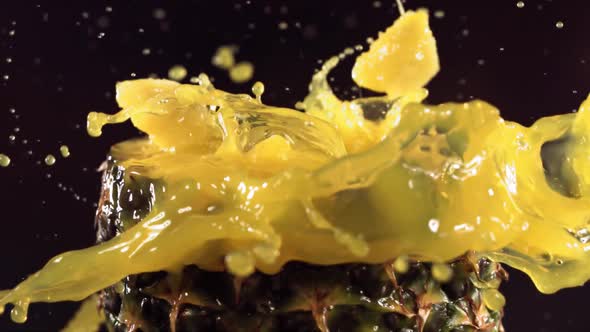 Pineapple Pieces Falling on the Surface of Half Pineapple in Slow Motion