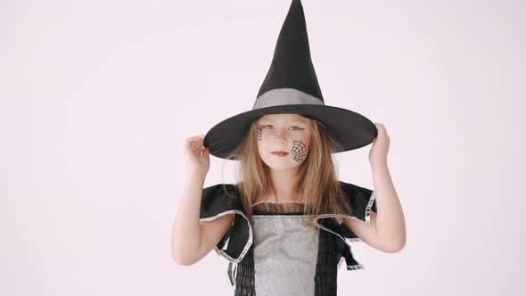 Portrait of Little Girl in Black Hat and Black Clothing on White Background