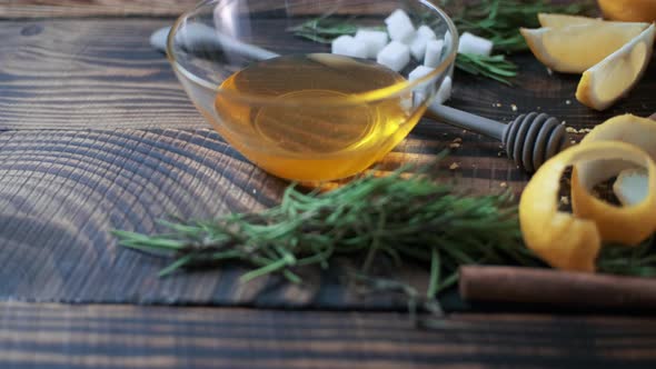 Honey in a Glass Jar and Lemon Peel on Wooden Boards