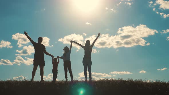 Happy Family Walking in Field on Sunny Day. Concept of Friendly Family.