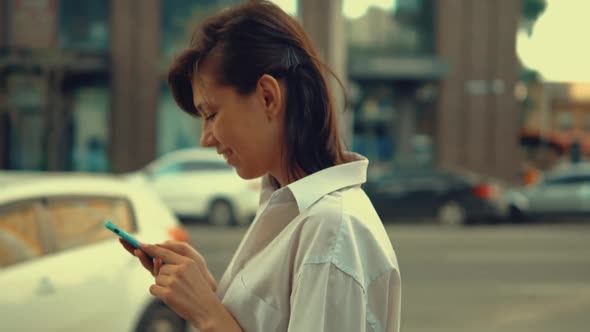 Businesswoman Typing Message on the Run