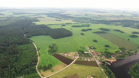 View From the Height of the Lake in a Green Field in the Form of a Horseshoe and a Village