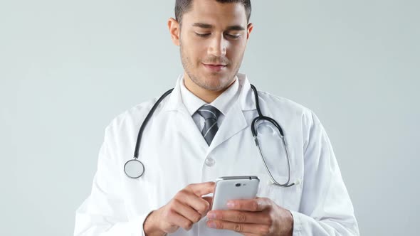 Smiling doctor using a smart phone 4K 4k