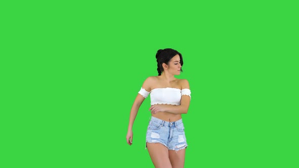 Adorable Hispanic Female Model in Denim Shorts Dancing on a Green Screen, Chroma Key