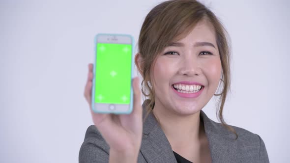 Face of Young Happy Asian Businesswoman Showing Phone