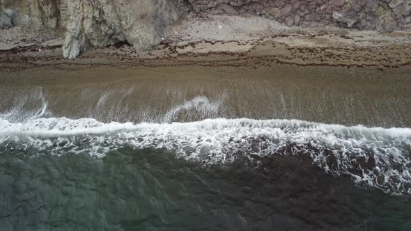 Aerial View From Above on Calm Azure Sea and Volcanic Rocky Shores