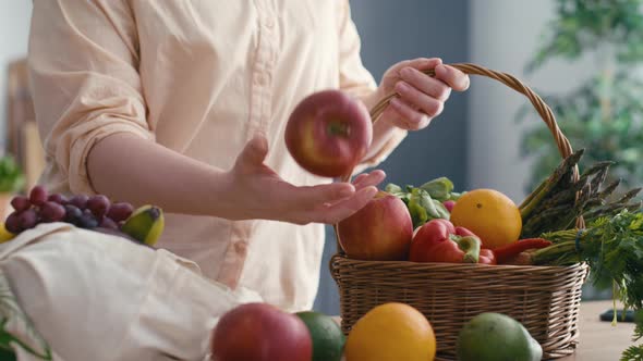 Woman pull in apple and other fruits lying around after the shopping