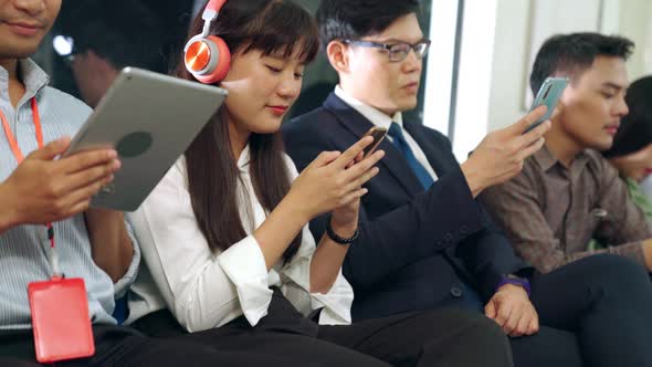 Young People Using Mobile Phone in Public Underground Train