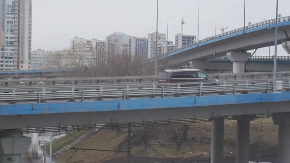 Industrial Urban View From Train Window. Bridges and Highways at Interchange Road Junction.