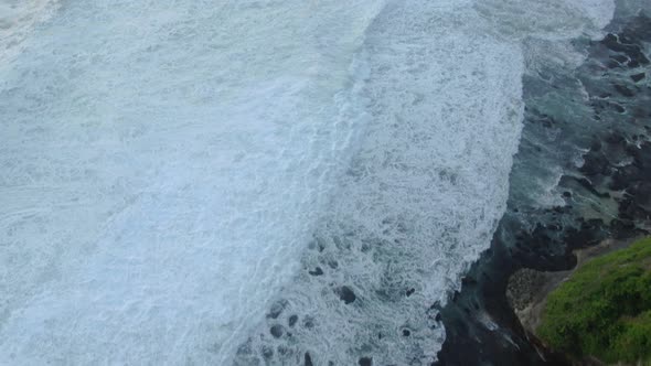 Top view of the giant waves, foaming and splashing in the ocean Bali, Indonesia