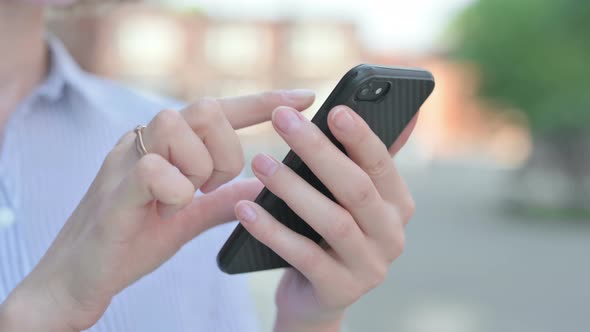 Close Up of Using Smartphone While Standing in Street