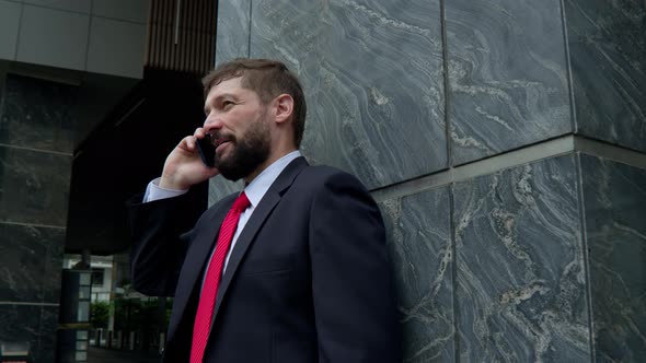 A Man is Talking on a Cell Phone in the Street