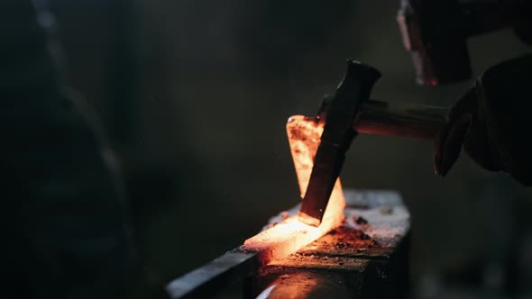 Handmade Blacksmithing in a Workshop. Blacksmith Forging Red-hot Blade of Knife in Smithy. The