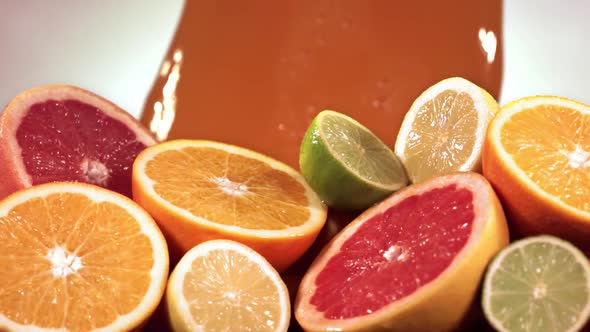 Slow Motion Shot of Citrus Fruits and Juice Splashing Through Lemon Lime Grapefruit Slices