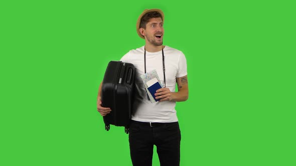 Tourist with Suitcase in Hand, Passport, Ticket and Map Is Looking Around and Enjoying. Green Screen