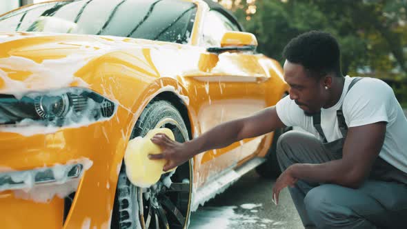 Luxury Modern Sport Car in Soap Foam Outdoors at Car Wash Service