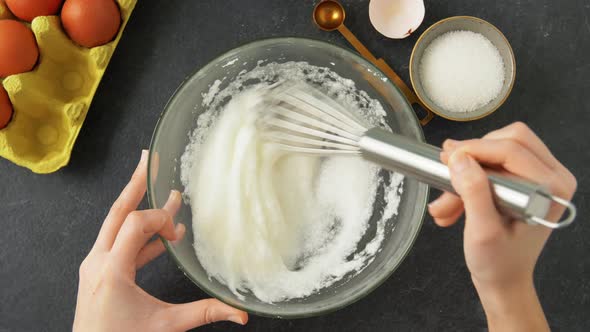 Hands Whipping Eggs Whites By Whisk in Bowl