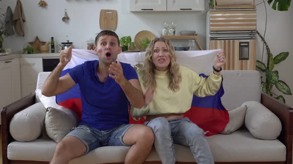 Family Couple of Football Fans at Home with Flag of Russia
