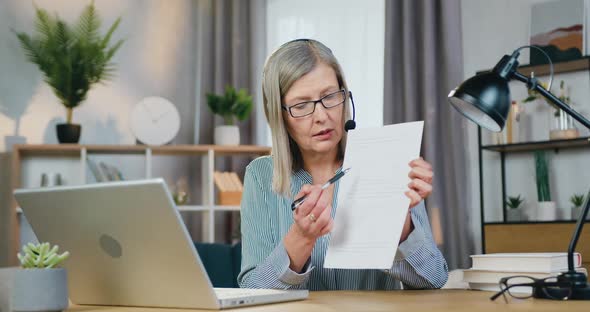 Aged Female Teacher Leading Online Lesson Using Laptop