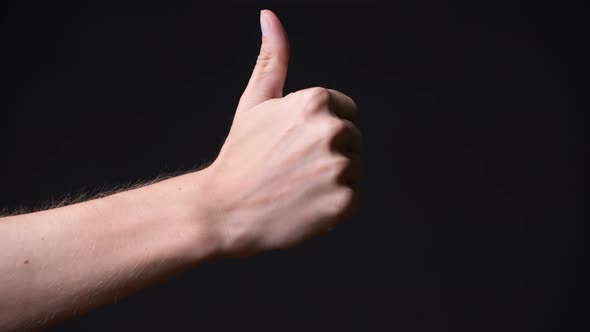 Hand of Young Man Giving Thumbs Up