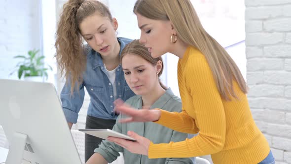 Hardworking Female Startup Team Using Tablet and Desktop