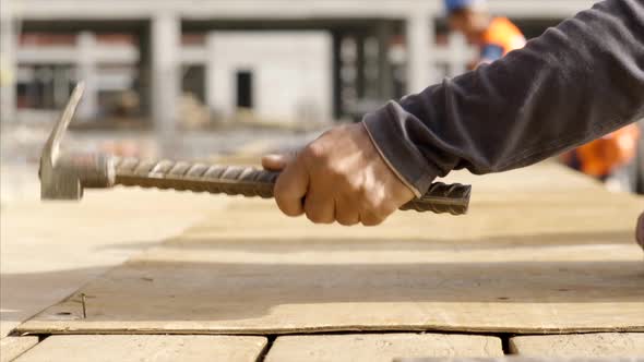 Dark Skinned Hand Male Construction Worker Hammering Nail 