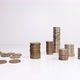 A female hand picks up coins from the table and counts them. Investment concept - VideoHive Item for Sale