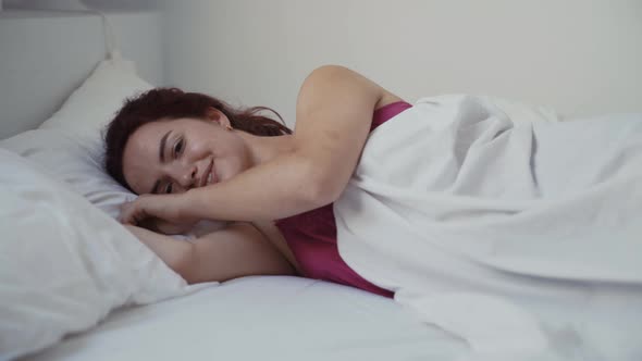 Young woman lying on bed