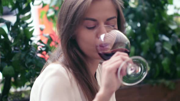 Young girl tasting wine