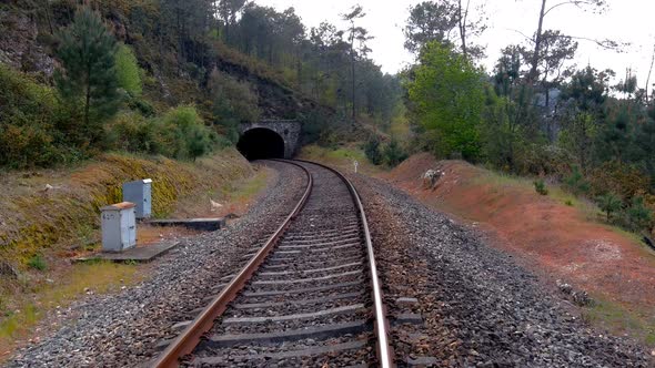 POV Along Empty Railway Tracks Approaching Tunnel Near Town Of Gundián, Vedra, Coruña, Galicia