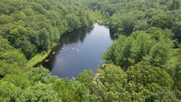 People Kayaking in the reservoir in Ashford,CT during a summer kids camp having fun.