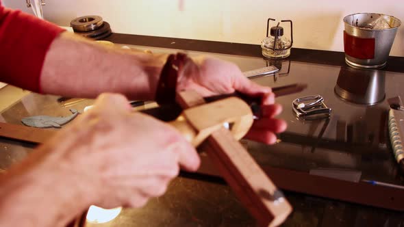 Tailor Cuts the Piece of Leather Using a Special Tool