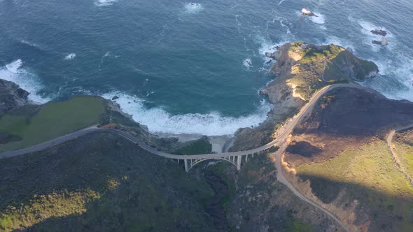 Aerial view of the picturesque arch bridge standing over the canyon. 