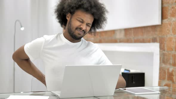 African Man with Back Pain at Work