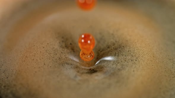 Super Slow Motion Detail Shot of Coffe Drop Falling Into Fresh Espresso at 1000 Fps