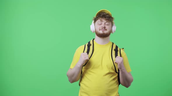 Portrait of Young Men Enjoying Music in Big White Headphones