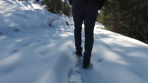 Man walking in snow, foot detail.