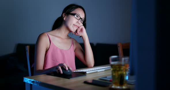 Asian woman working on computer at night 