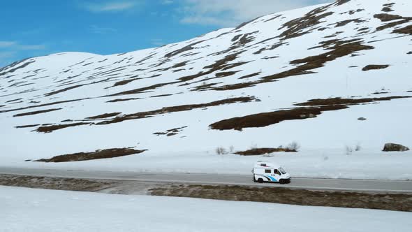 Small Vintage Camper RV on Mountain Road in Norway