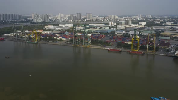 Aerial Hyperlapse of ships and boats moving and view of port on the Saigon river on a quiet sunny da