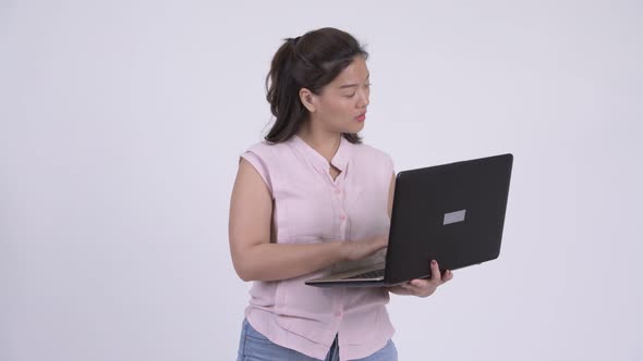 Young Happy Asian Businesswoman Using Laptop