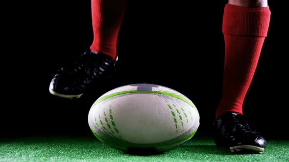 Professional rugby sportsman put his foot on the ball