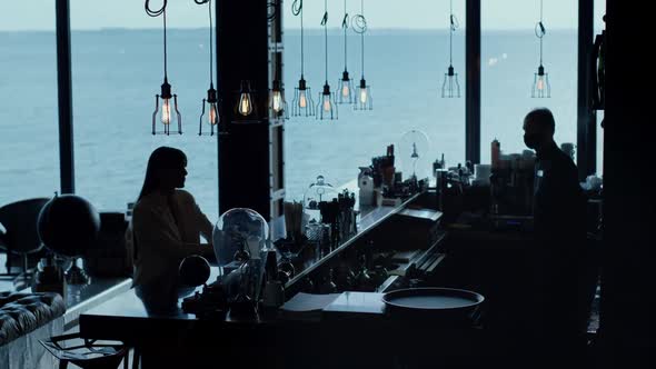 Woman Silhouette Ordering Cocktail Ocean View