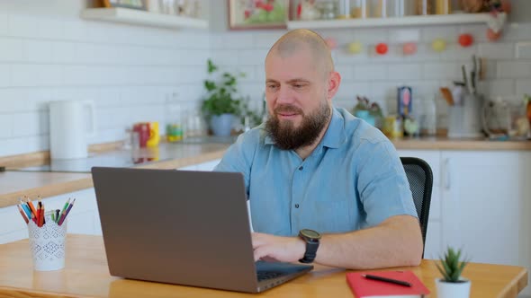 Portrait of Smiling Senior Man Working or Studying Remotely at Home