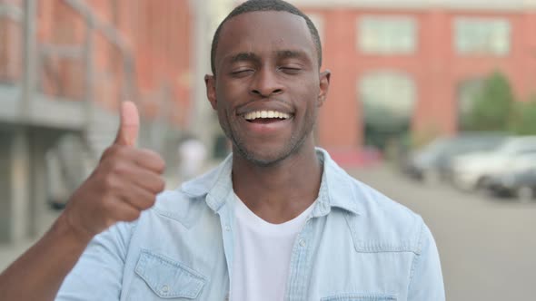 Portrait of African Man Showing Thumbs Up Sign Outdoor