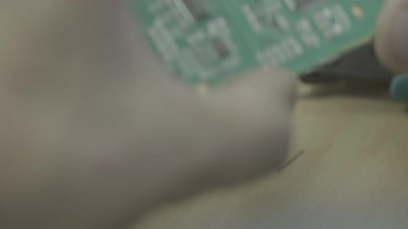 A Worker Is Working on the Production of an Electronic Board. Close-up.