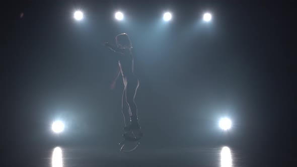 Girl in Sports Suit Doing Exercises in Kangoo Jumps Shoes.