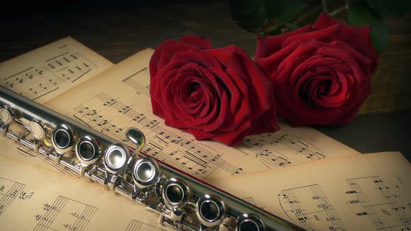 Flute And Roses On Sheet Music Performance Concept