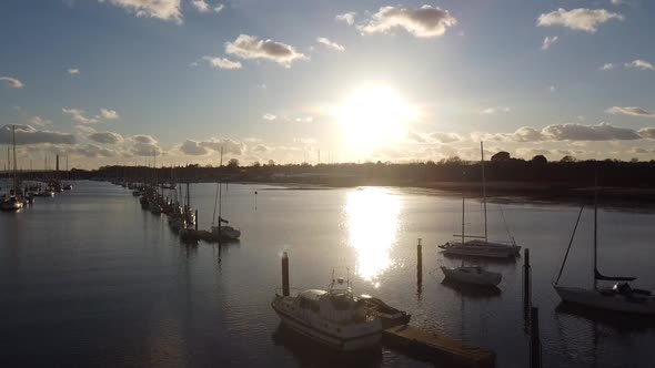River hamble aerial drone footage of evening sunset over water